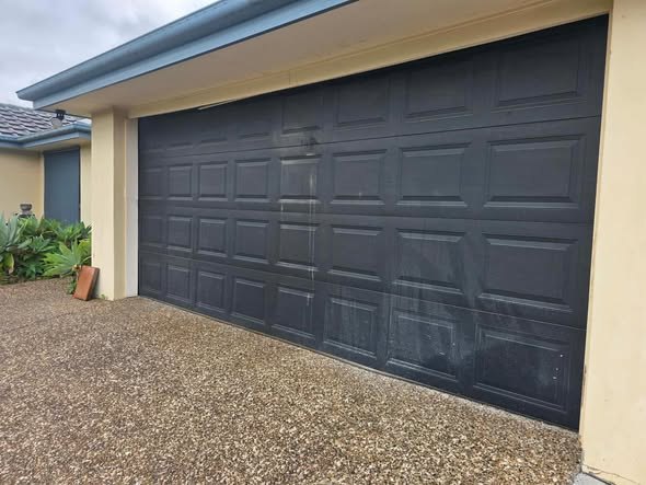 Black panel-lift sectional garage door on a Gold Coast home
