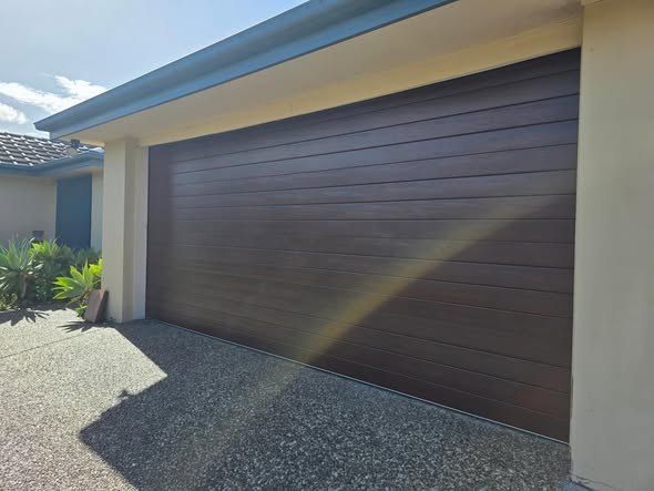Woodgrain sectional garage door on a Gold Coast home